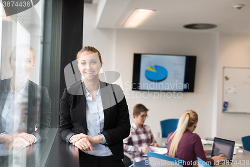 Image of portrait of young business woman at office with team on meeting 