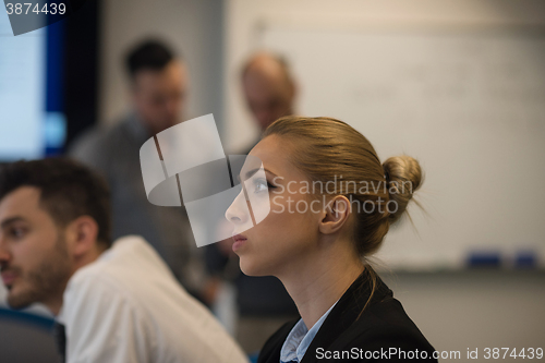 Image of portrait of young business woman at office with team on meeting 