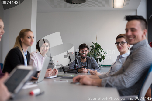 Image of close up of  businessman hands  using tablet on meeting