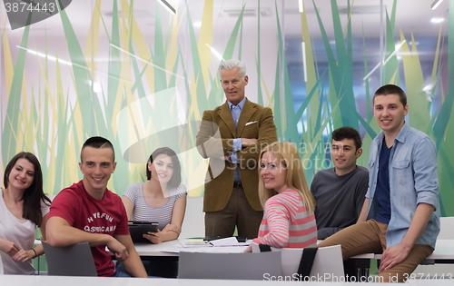 Image of portrait of  teacher with students group in background