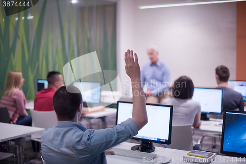 Image of student answering a question in classroom