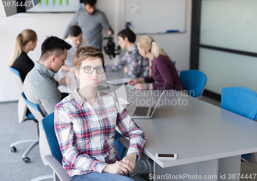 Image of portrait of young business woman at office with team on meeting 