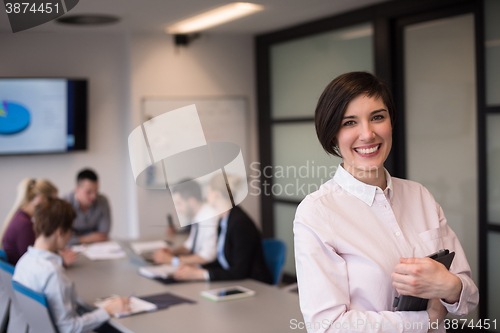 Image of hispanic businesswoman with tablet at meeting room