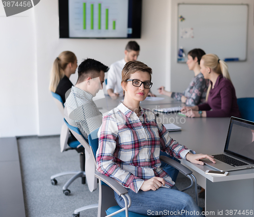 Image of portrait of young business woman at office with team on meeting 