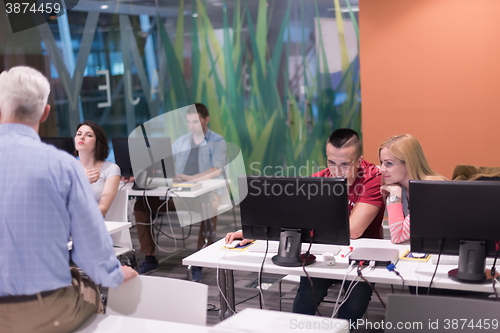 Image of teacher and students in computer lab classroom