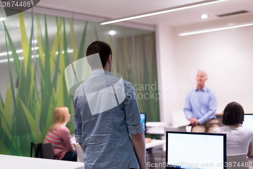 Image of student answering a question in classroom