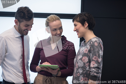 Image of young business people group working on tablet