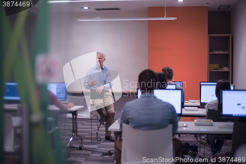 Image of teacher and students in computer lab classroom