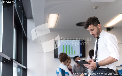 Image of young business man with tablet at office meeting room