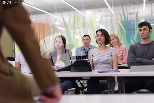 Image of teacher with a group of students in classroom