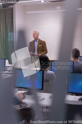 Image of teacher and students in computer lab classroom
