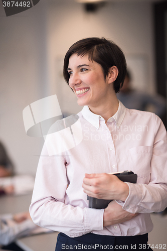 Image of hispanic businesswoman with tablet at meeting room