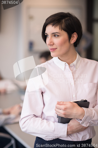 Image of hispanic businesswoman with tablet at meeting room