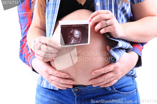 Image of pregnancy woman with ultrasound photo 