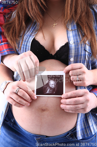 Image of pregnancy woman with ultrasound photo 