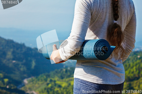 Image of Woman standing with yoga 