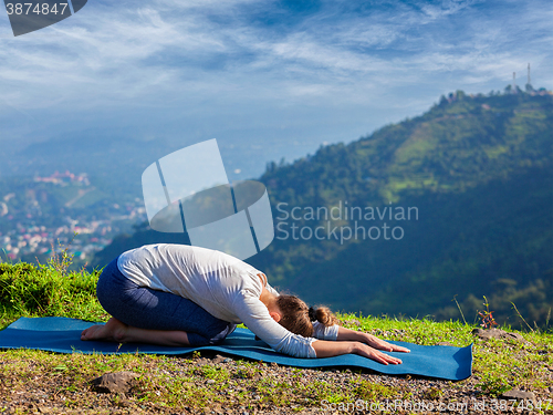 Image of Sporty fit woman practices yoga asana Balasana