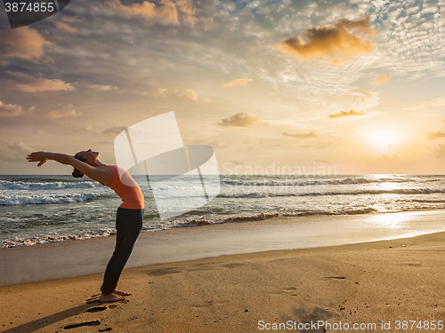 Image of Woman doing yoga Sun salutation Surya Namaskar 