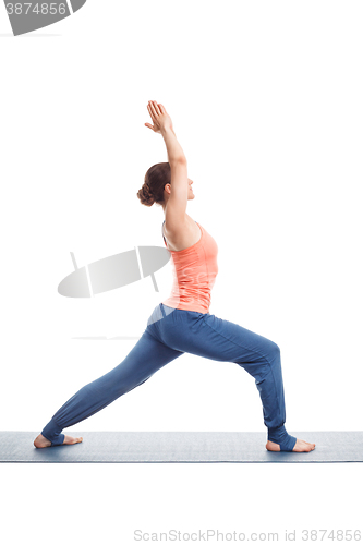 Image of Woman practices yoga asana utthita Virabhadrasana
