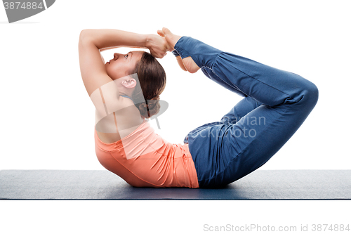 Image of Sporty fit woman practices yoga asana Dhanurasana