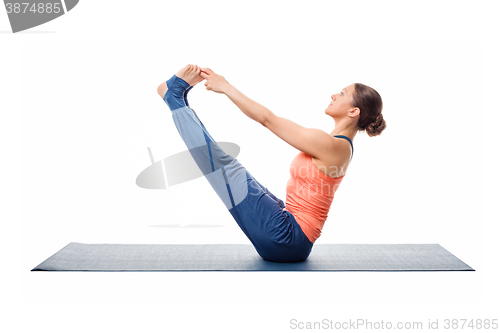 Image of Beautiful sporty fit woman practices yoga asana