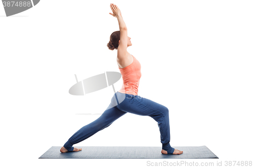 Image of Woman practices yoga asana utthita Virabhadras