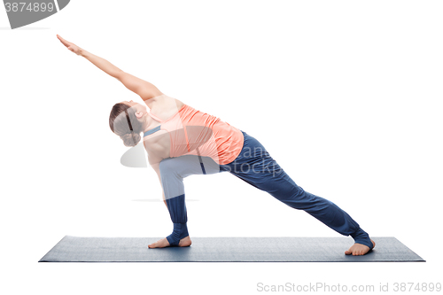 Image of Young fit woman doing Ashtanga Vinyasa Yoga