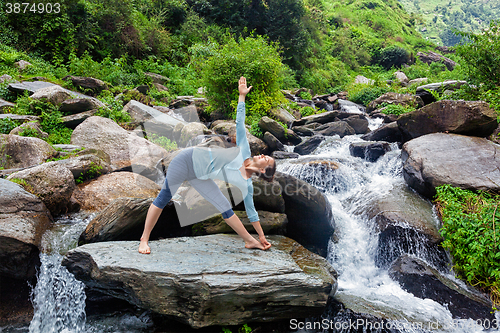 Image of Woman doing Ashtanga Vinyasa yoga asana  outdoors