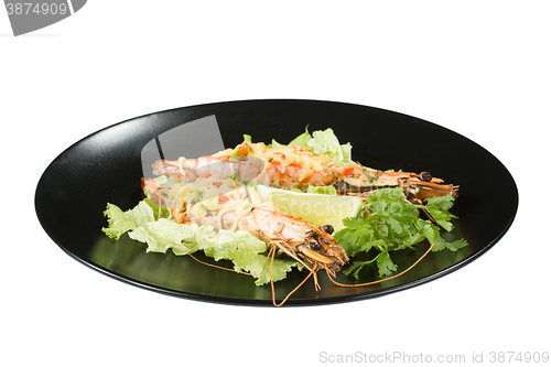 Image of perfect dish with shrimps on a black plate. seafood