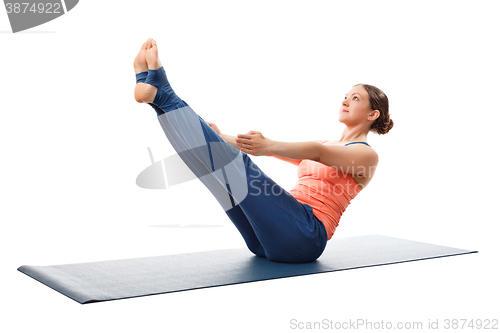 Image of Woman practices yoga asana Paripurna navasana