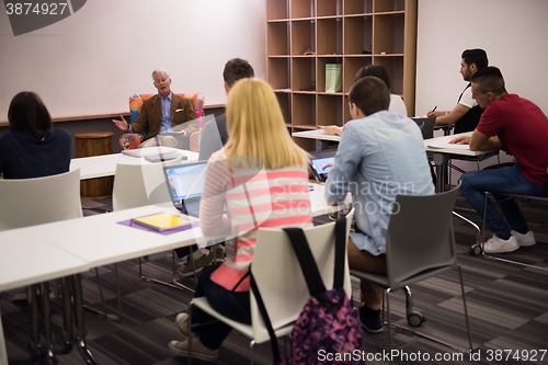 Image of teacher with a group of students in classroom