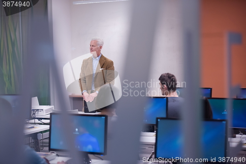 Image of teacher and students in computer lab classroom