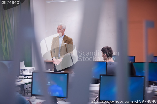 Image of teacher and students in computer lab classroom