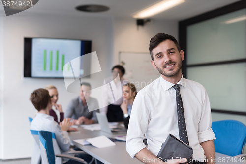 Image of young business man with tablet at office meeting room