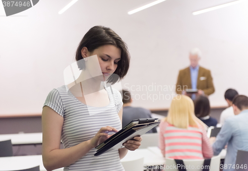 Image of portrait of happy female student in classroom