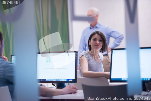 Image of technology students group in computer lab school  classroom