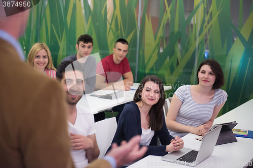 Image of teacher with a group of hi school students in classroom