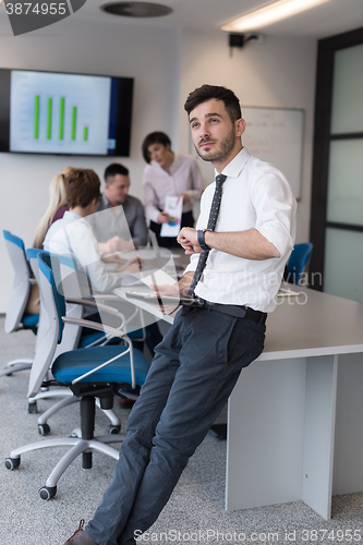 Image of young business man with tablet at office meeting room