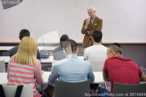 Image of teacher with a group of students in classroom