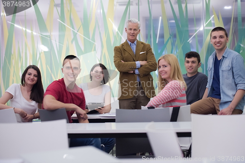 Image of portrait of  teacher with students group in background
