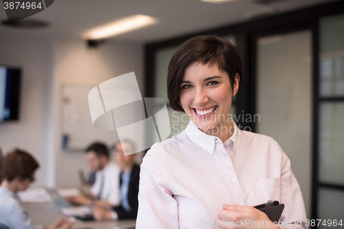 Image of hispanic businesswoman with tablet at meeting room