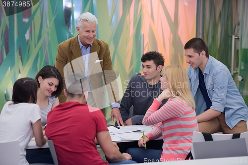 Image of teacher with a group of students in classroom