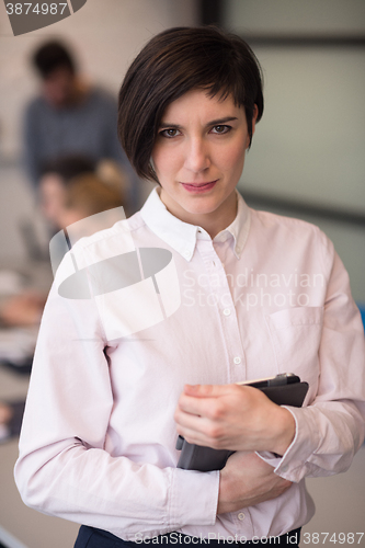 Image of hispanic businesswoman with tablet at meeting room