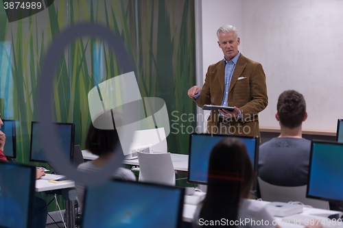 Image of teacher and students in computer lab classroom