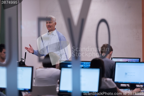 Image of teacher and students in computer lab classroom