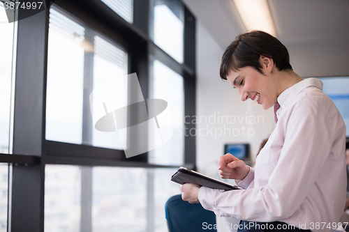 Image of business woman on meeting  using tablet