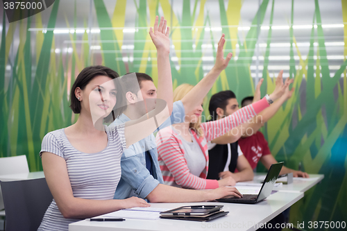 Image of students group raise hands up