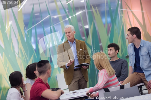 Image of teacher with a group of students in classroom