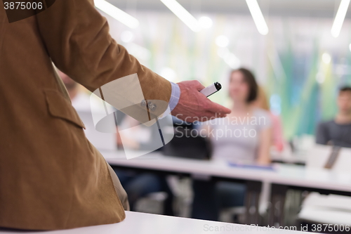 Image of close up of teacher hand while teaching in classroom