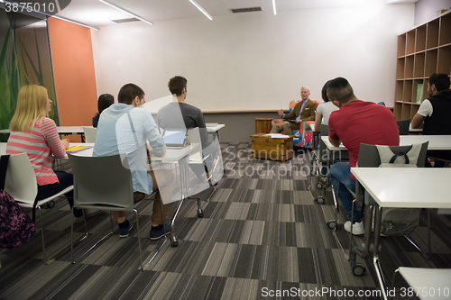 Image of teacher with a group of students in classroom